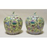 A pair of Chinese yellow ground gourd jars and covers
