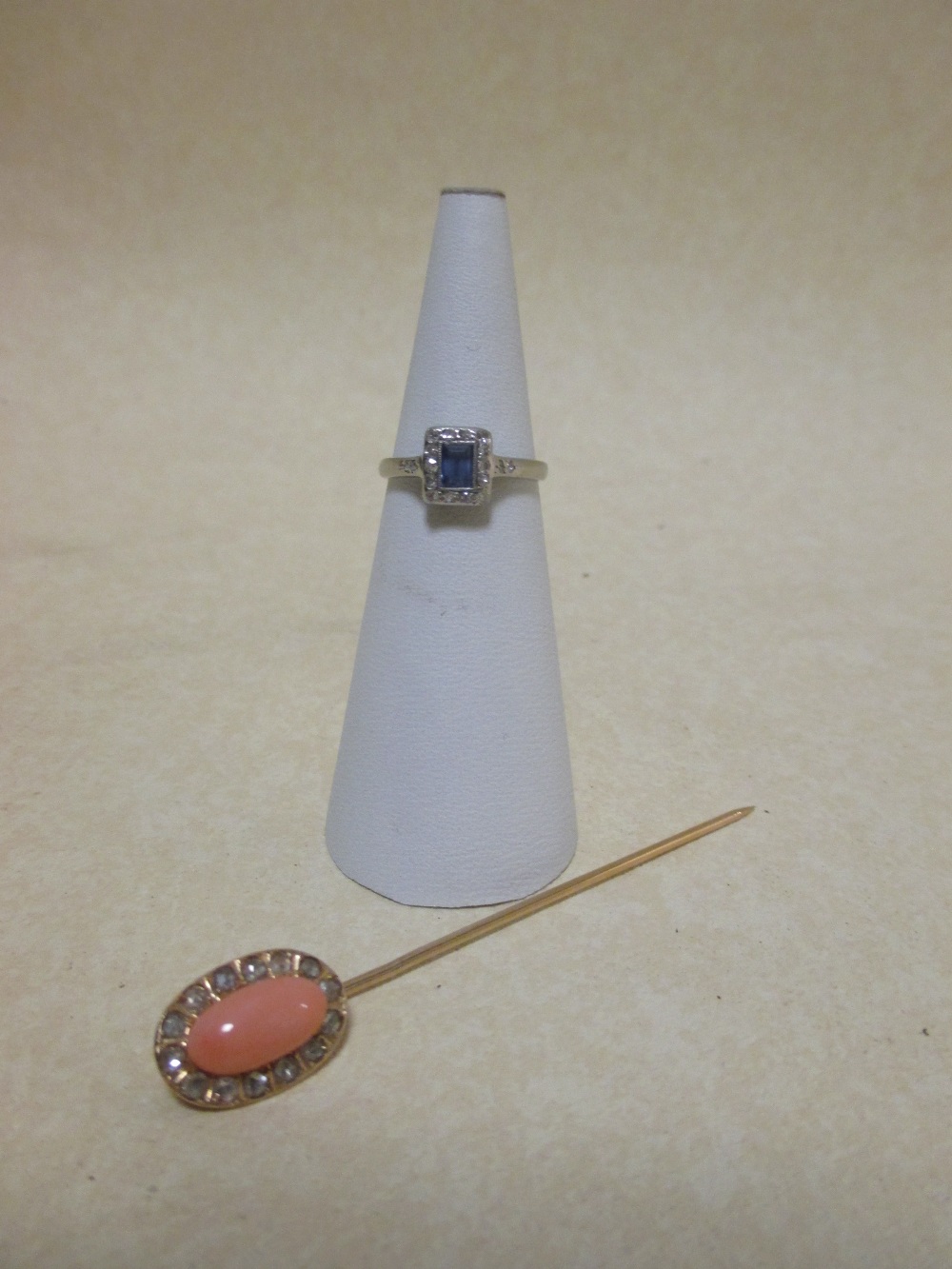 A coral stick pin and small dress ring (2)