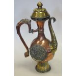 A Tibetan brass and copper pouring vessel