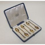 A set of six silver gilt coffee spoons with enamelled handles, Birmingham 1913 or 1938