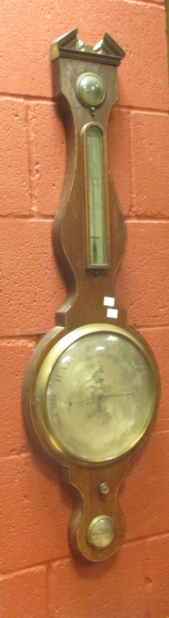 A George IV mahogany 'banjo' cased barometer, silvered dial, thermometer and level, signed J