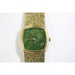 By Piaget - a lady's 18ct gold wristwatch, the rounded square dial with textured bezel, nephrite