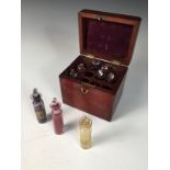 A 19th century mahogany cased set of bottles, each containing various coloured pigments 12 x 13 x