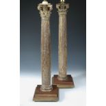 A pair of painted and parcel gilt column table lamp bases, the fluted Corinthian columns raised on