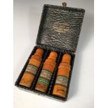 Ahmed Soliman, a cased set of three treen cased perfume bottles, each of turned boxwood with