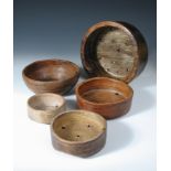 Five 19th century treen cheese vats or chessels, each of the graded cylindrical shapes pierced