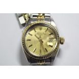 By Rolex - a lady's 'Oyster Perpetual Date' steel cased wristwatch, champagne dial with baton