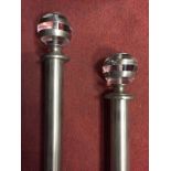 A pair of McKinney & Co. silvered metal curtain poles, with glass finials 250 x 3.5cm (98 x 1in)