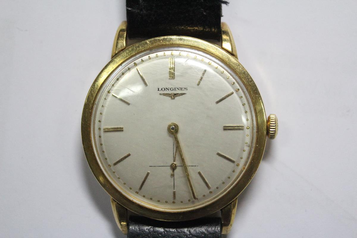 By Longines - a 1950's gentleman's 18ct gold cased wristwatch, the silvered dial with gold