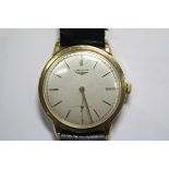 By Longines - a 1950's gentleman's 18ct gold cased wristwatch, the silvered dial with gold