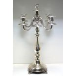 A German (probably) part metalwares candelabrum, the circular base with four vine headed feet