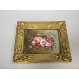 A British pottery gold framed plaque painted with flowers, 13.5 x 16.5cm