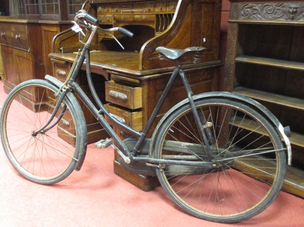 A vintage lady's bicycle with rod brakes and leather saddle