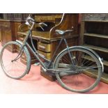 A vintage lady's bicycle with rod brakes and leather saddle