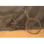 A vintage lady's bicycle with rod brakes and Brooks leather saddle