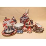 A Japanese Imari covered vase, a pair of vases, a pair of Arita flask vases another Imari vase and