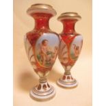 A pair of 19th century Bohemain opaque and cranbery vases, with cherub painted panels and gilt