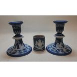 A pair of Wedgwood blue jasperware candlesticks and an armorial vesta (3)