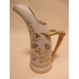 A Royal Worcester blush ground ewer jug with stylised horn handle and gilt floral decoration,