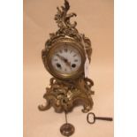 A late 19th/early 20th century French ormolu mantel clock, pendulum and key, 29cm high