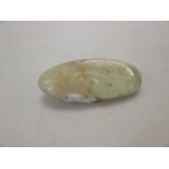 A 19th century Chinese carved and polished russet jade pebble