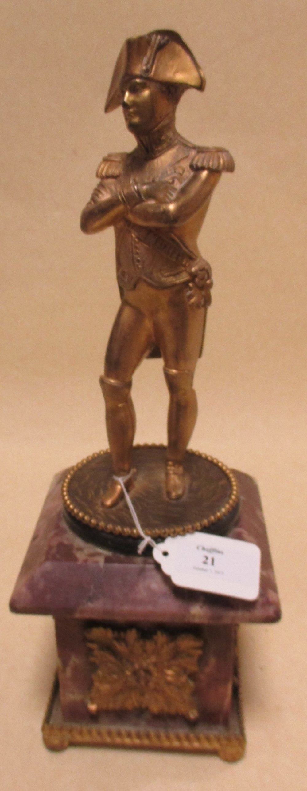 A bronze figure of Napoleon standing on a purple marble base, 35cm high
