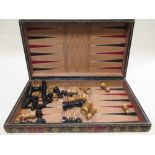 A folding leather Chess/Backgammon Board and two chess sets and a draughts set