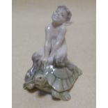 A Royal Copenhagen model of a faun riding a tortoise, 9.5cm high