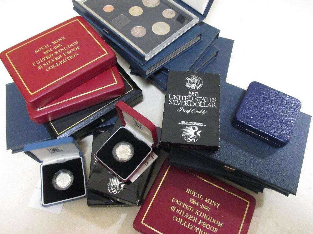 A collection of cased modern British silver proof, commemorative and other coins, including 1984-