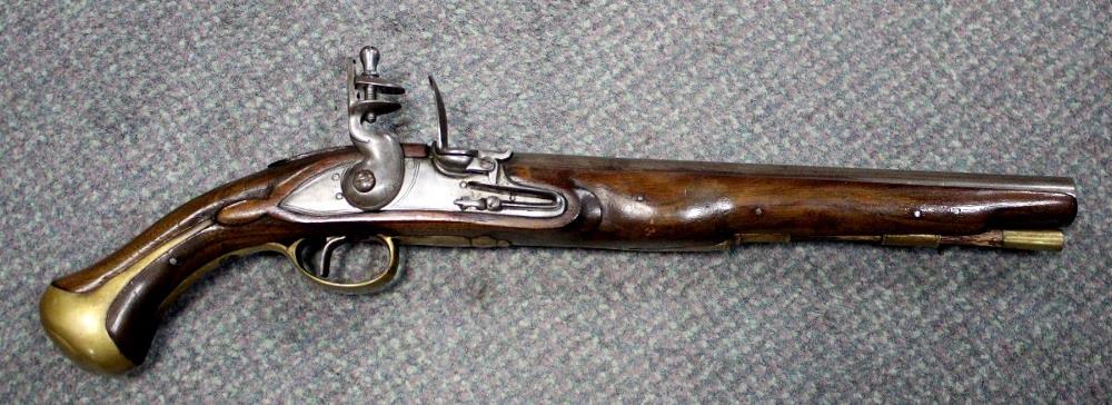 WITHDRAWN A flintlock holster pistol, with walnut stock, unsigned lock, brass furniture, ramrod