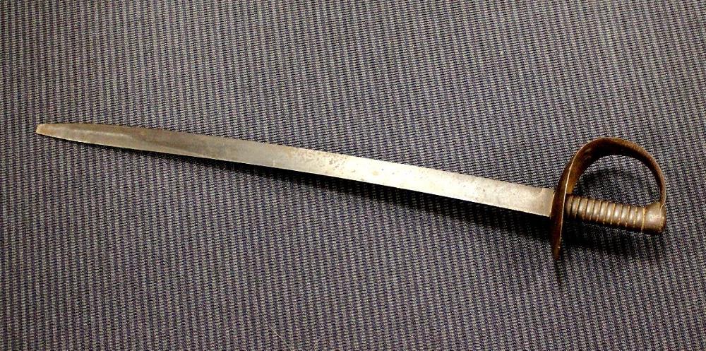 A 19th century naval boarding cutlass, the blade tipped and stamped C/87, solid basket hilt with