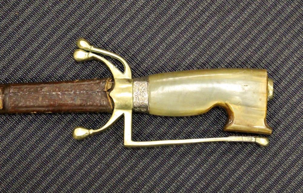 An Arabian nimcha (curved bladed sword) with brass mounted horn handle, plain steel blade, and - Image 2 of 3