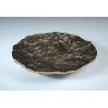 Kaj Blomquist, a textured and polished bronze dish circa 1970s, the rugged textured surface to a