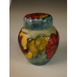 A Moorcroft Hibiscus pattern jar and cover, decorated to a pale blue ground, impressed marks and