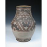 A large Carter, Stabler Adams Poole pottery vase, the unglazed baluster form painted with brown