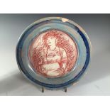 Quentin Bell, a Fulham Pottery plate, centrally incised with a woman reading or singing from a