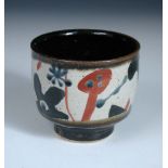 John Maltby (born 1936), a stoneware pot, of circular form raised on a foot, decorated with a band