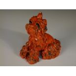 Ida Meisinger for Goldscheider, an orange glazed model of a terrier, seated, printed and impressed