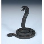 Edgar Brandt (1880-1960) a wrought iron paperweight or watch holder modelled as a serpent, stamped