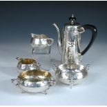A harlequin silver coffee set by Charles Edwards, London, dates vary from 1903 to 1922, comprising