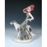 A Joesef Schuster model of a lady with a Borzoi, probably designed by Josef Lorenzl, modelled in a