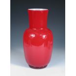 A Venini cased glass vase, the red glass baluster form with white interior, signed to base 33cm (