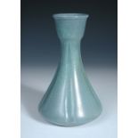 An early Ruskin vase, the fluted bottle form vase with duck egg blue to purple glaze, impressed