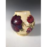 A Moorcroft Anemone pattern vase, the globular form decorated to a yellow ground, painted and