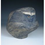 A studio pottery stoneware model of a stylised monkey, glazed in blues, indistinct signature to