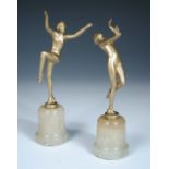 A pair of gilt painted models of dancers in the manner of Josef Lorenzl, one dancing clothed, the