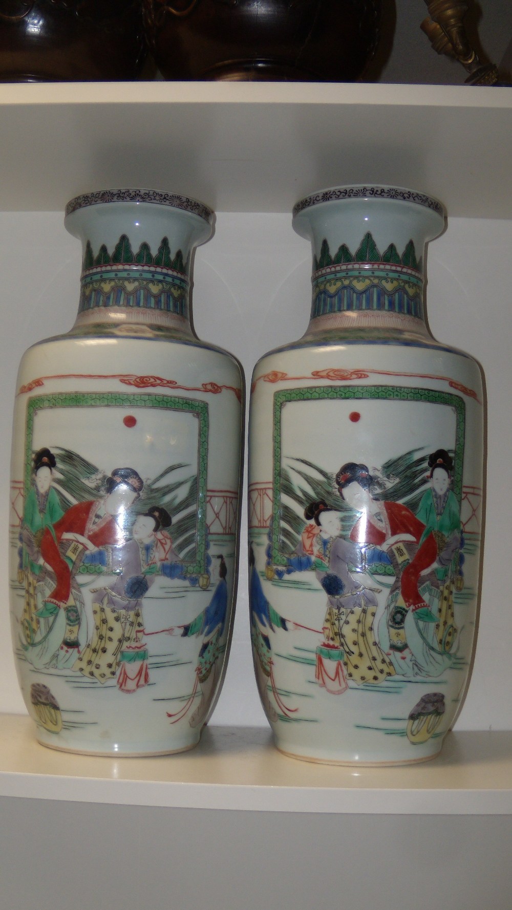 A pair of Kangxi style famille verte vases, each painted with ladies on a terrace and before a