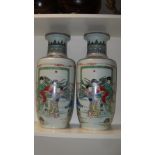 A pair of Kangxi style famille verte vases, each painted with ladies on a terrace and before a