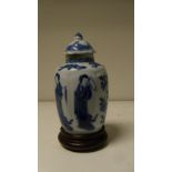 A blue and white jar, period of Kangxi, with a later cover and a wood stand, the lobes of the