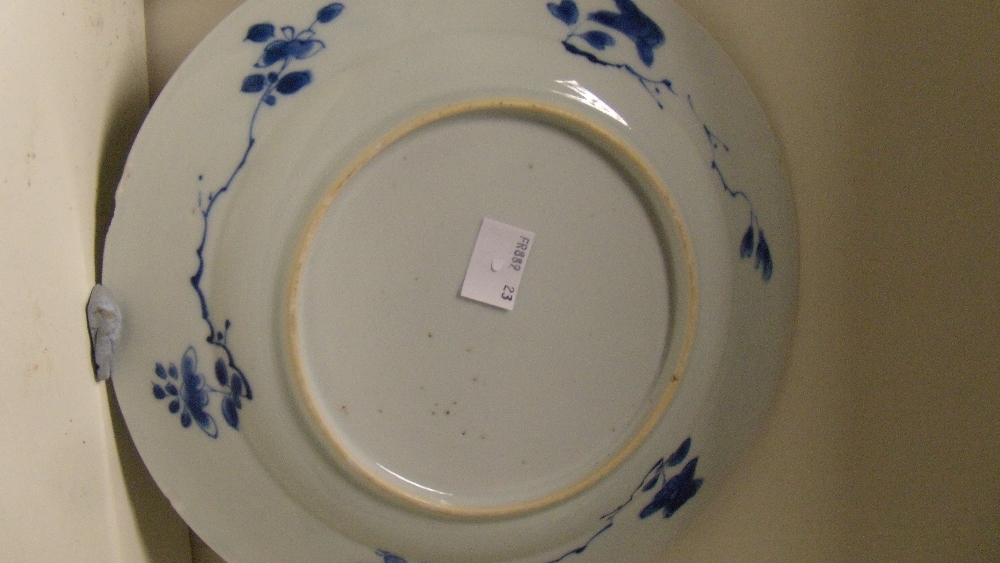 A pair of blue and white plates, period of Kangxi, each centrally painted with a boy waving from a - Image 3 of 3